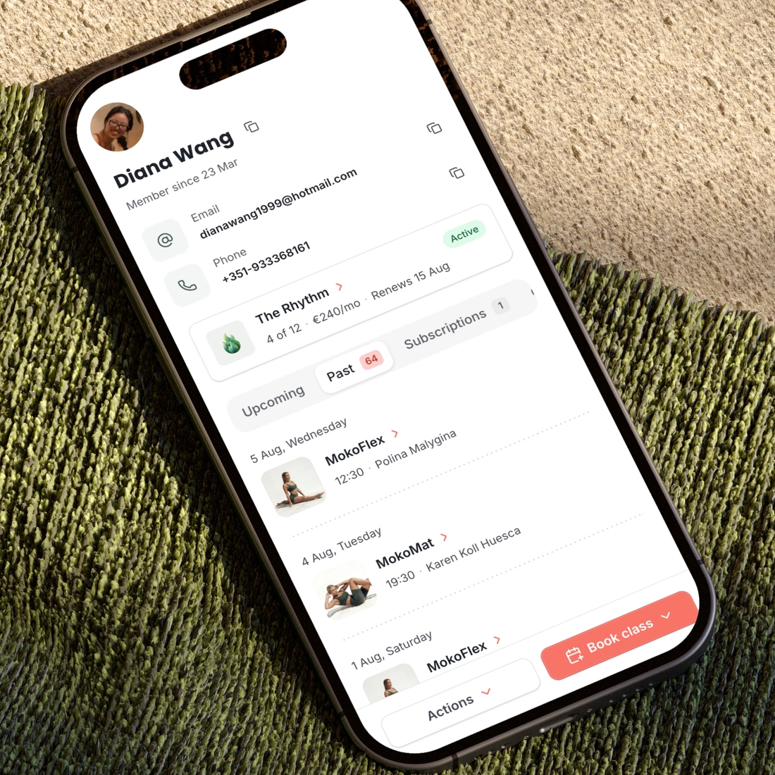 A phone on a blanket, showing a customer’s page in the admin with their membership and their next classes.